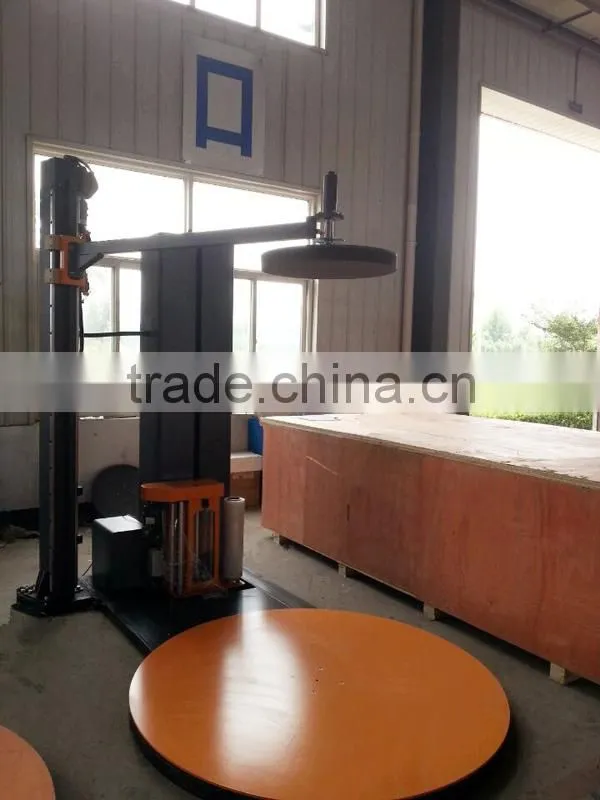Wrapping machine type motorized top platen pallet wrapping machine