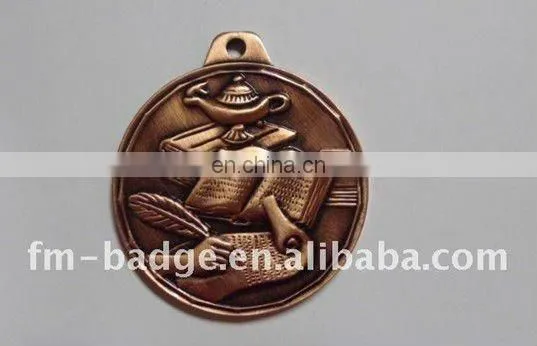 antique brass medal with an oil lamp book and feather with writing