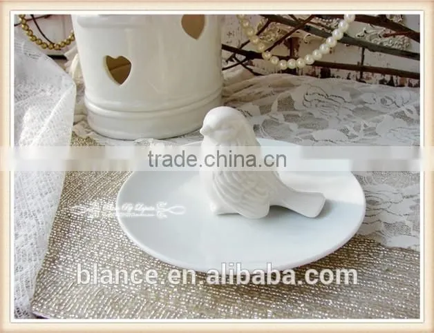 antique white porcelain plate with small bird in middle