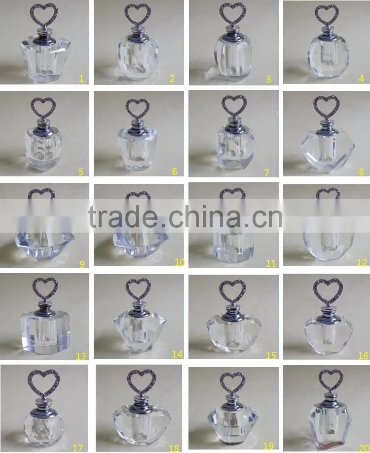 small empty clear crystal perfume bottle with jewelled metal alloy handle