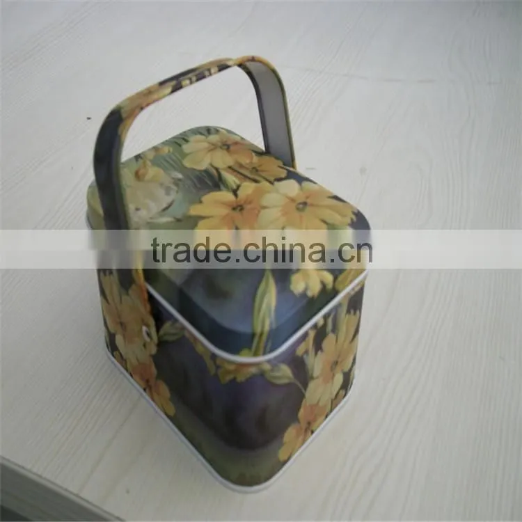 unique shaped metal tea can with handle