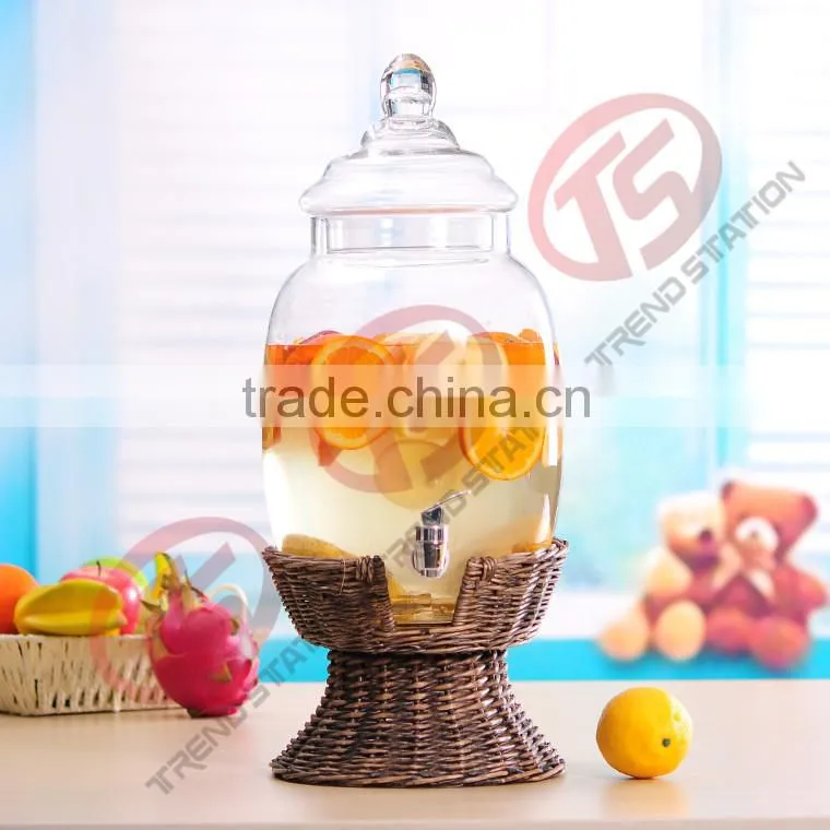 large glass beverage dispenser with willow base and spigot