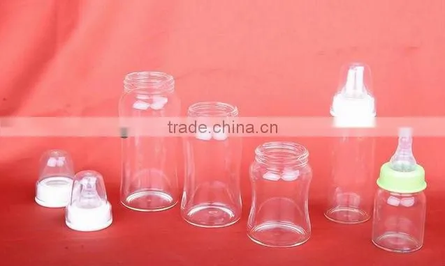 Glass baby bottle with red cap