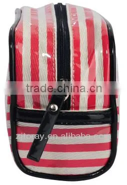Small clear coated cosmetic bag featuring a coated stripe pattern zippered placket along the top