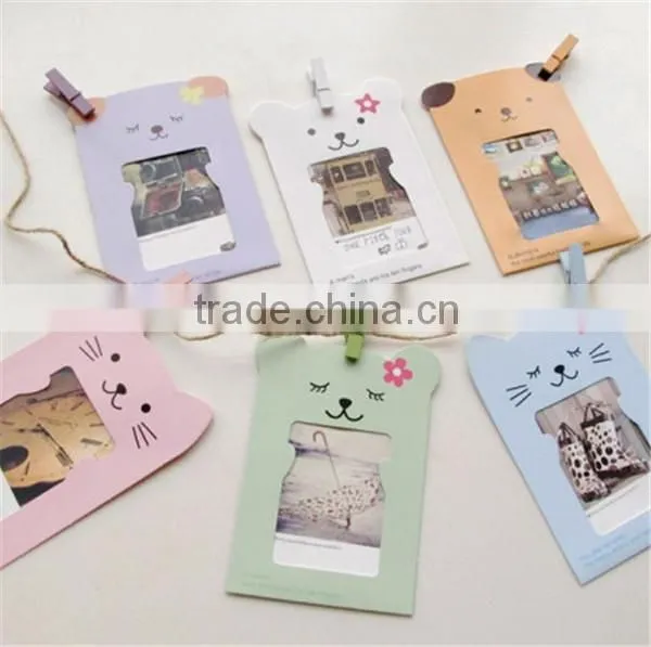 Recyclable paper picture photo frames hanging over at the rope with wood clamp