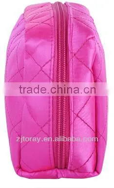 Lightweight quilted cosmetic bag featuring a zippered placket along the top and sides