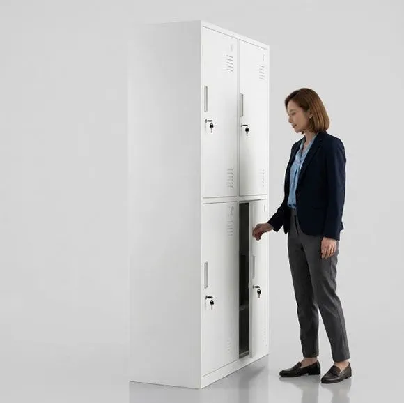 Office worker opening upper compartment of 4 door steel locker