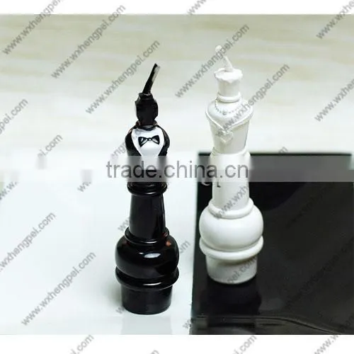Wedding candles on the chess king and queen
