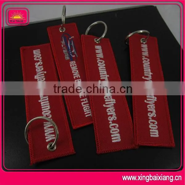 customized remove before flight spinning keychain