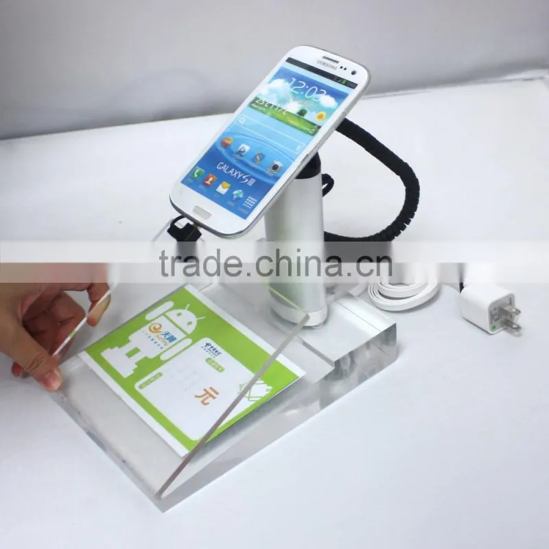 Alarm and charging of cell phone display holder