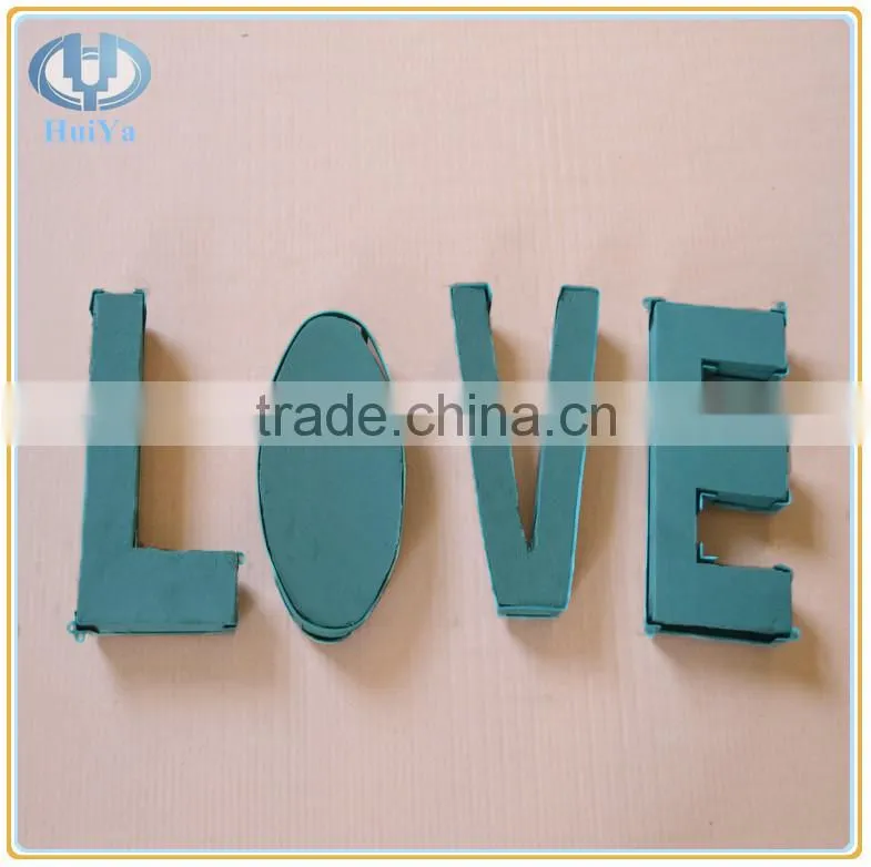 wet green floral foam letters with plastic case