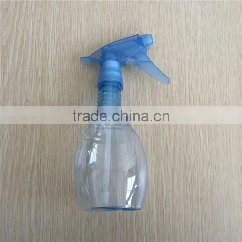 blue transparent plastic garden spray bottle with trigger