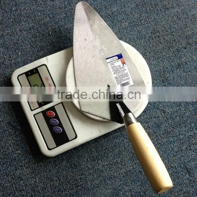 Professional construction tools brick with wood handle trowel