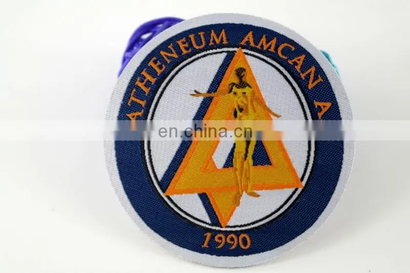 die cut shape with logo book and bird woven military emblems