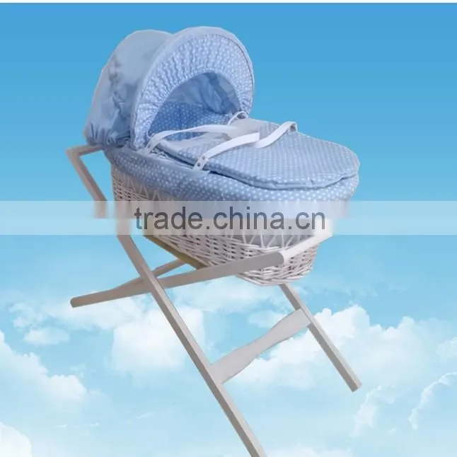 White wicker baby bassinet with cosy dressings