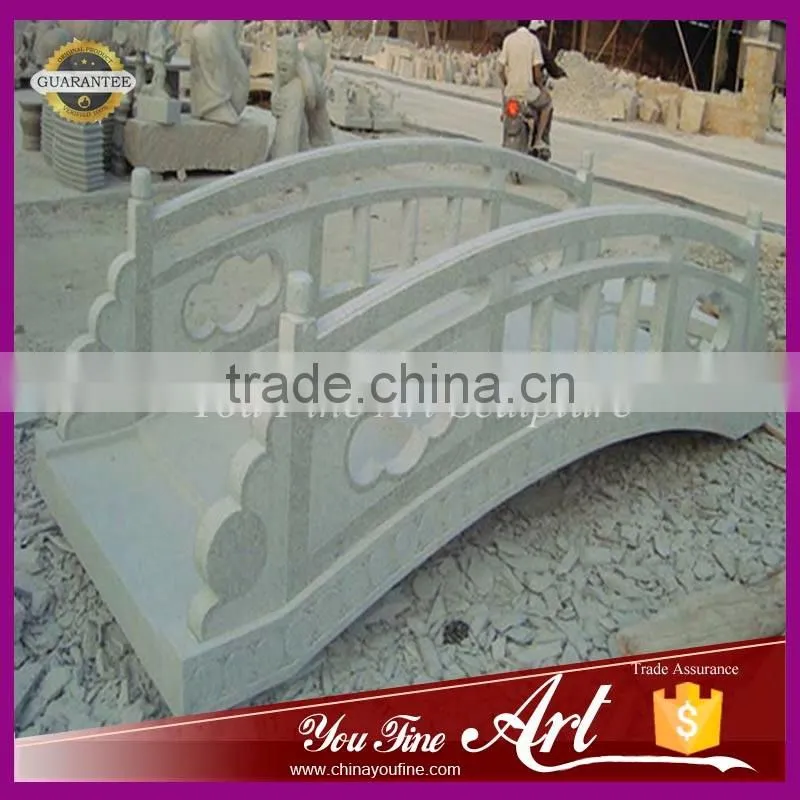 decorative garden bridge in stone