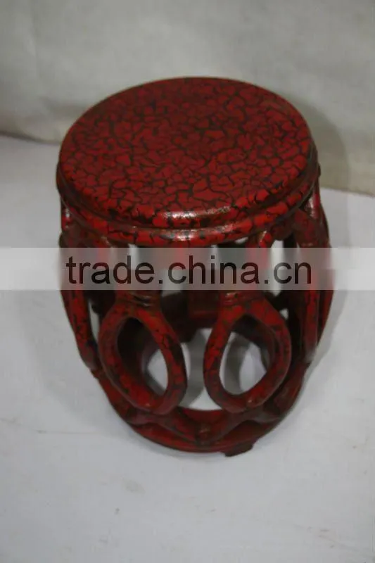 red wooden flower stool