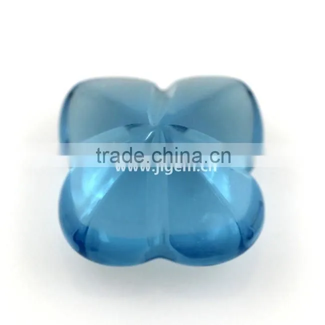 Synthetic glass gem stone with four leaf clover stone