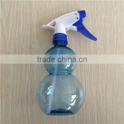 blue transparent plastic garden spray bottle with trigger