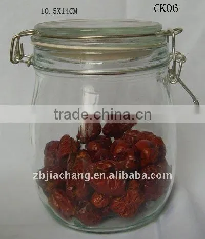 Clear glass food storage bottle with metal clip