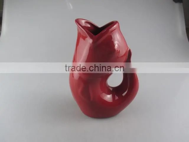 red-glazed ceramic fish vase