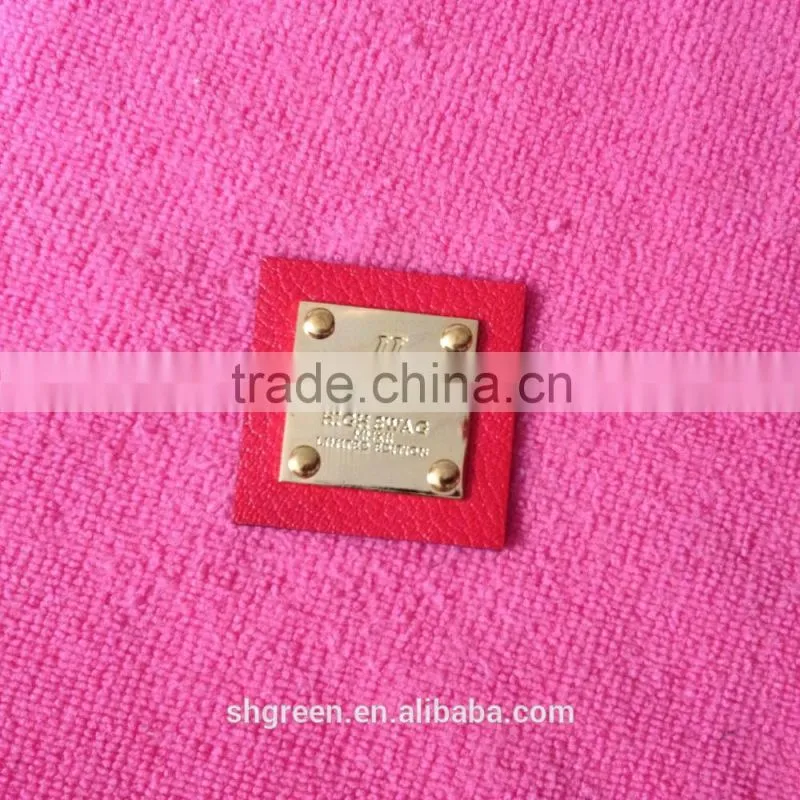 Shiny golden color metal badge on black leather
