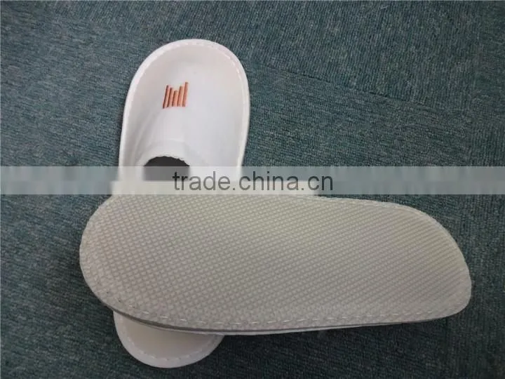 Brand new white fluffy indoor hotel bathroom slippers
