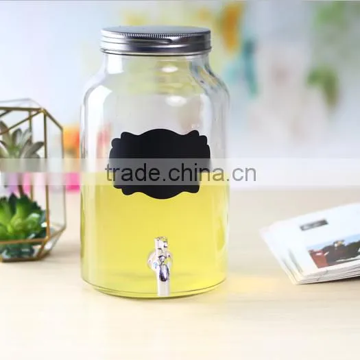 Glass beverage dispenser with black sticker and tap