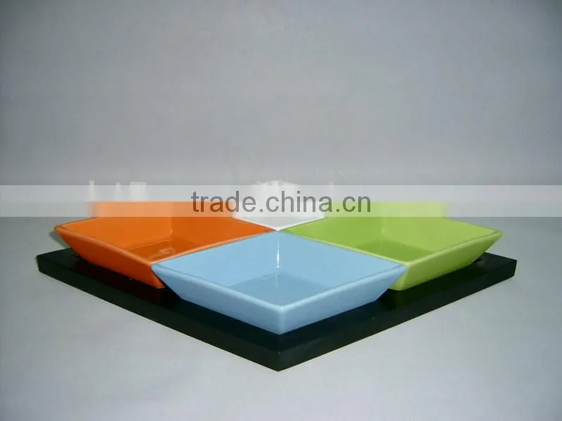 Colorful ceramic snack plates with wooden tray