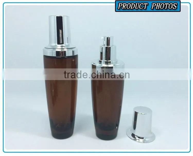 Amber coloured cosmetic glass lotion bottles with silver pump cap