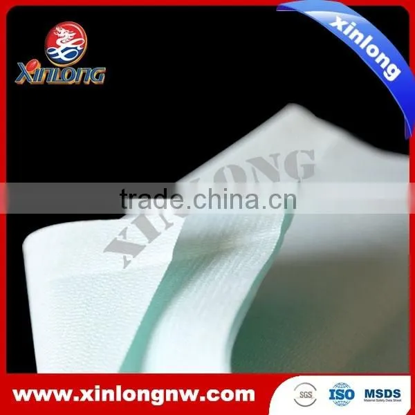 Creped nonwoven spunlace woodpulp polyester