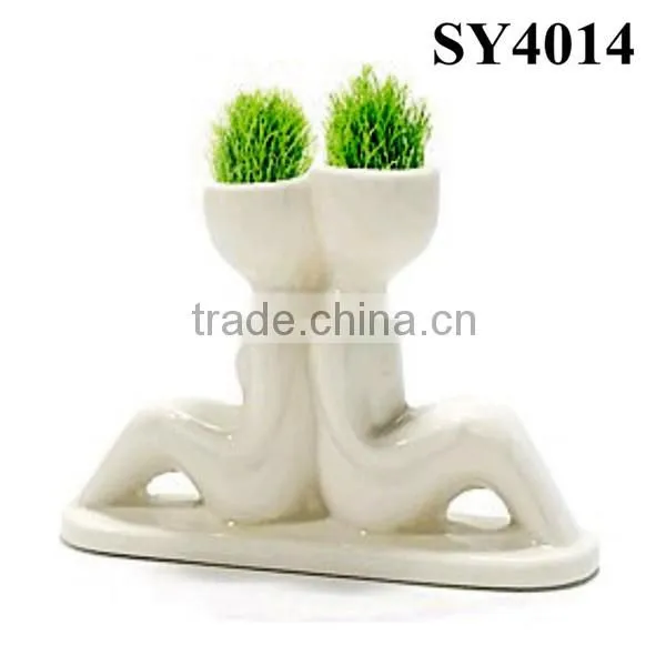 With grass hair white man growing grass doll
