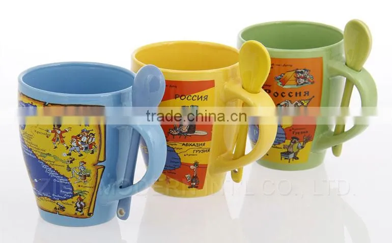 coloured ceramic coffee mug with design printing and spoon in handle