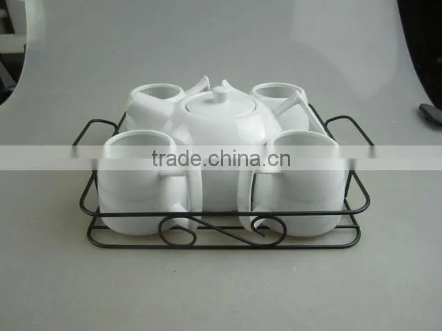 white porcelain tea set with metal stand