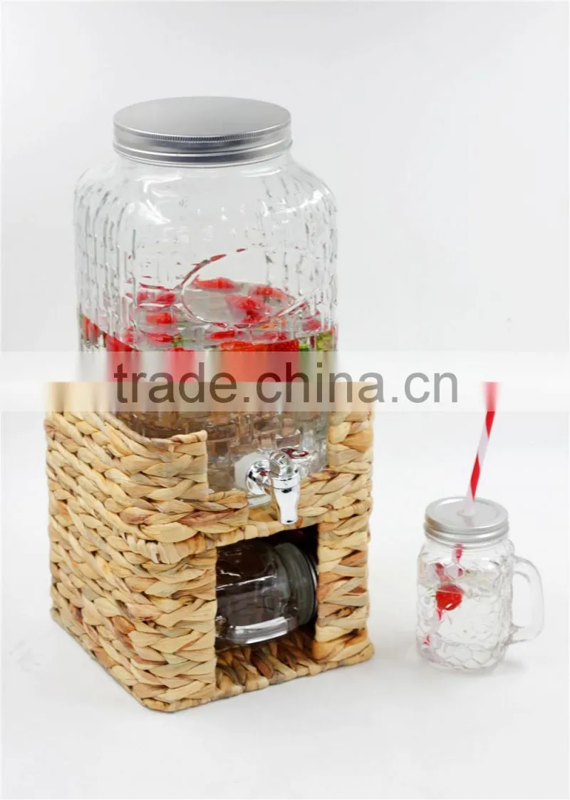 glass beverage dispenser on grass stand