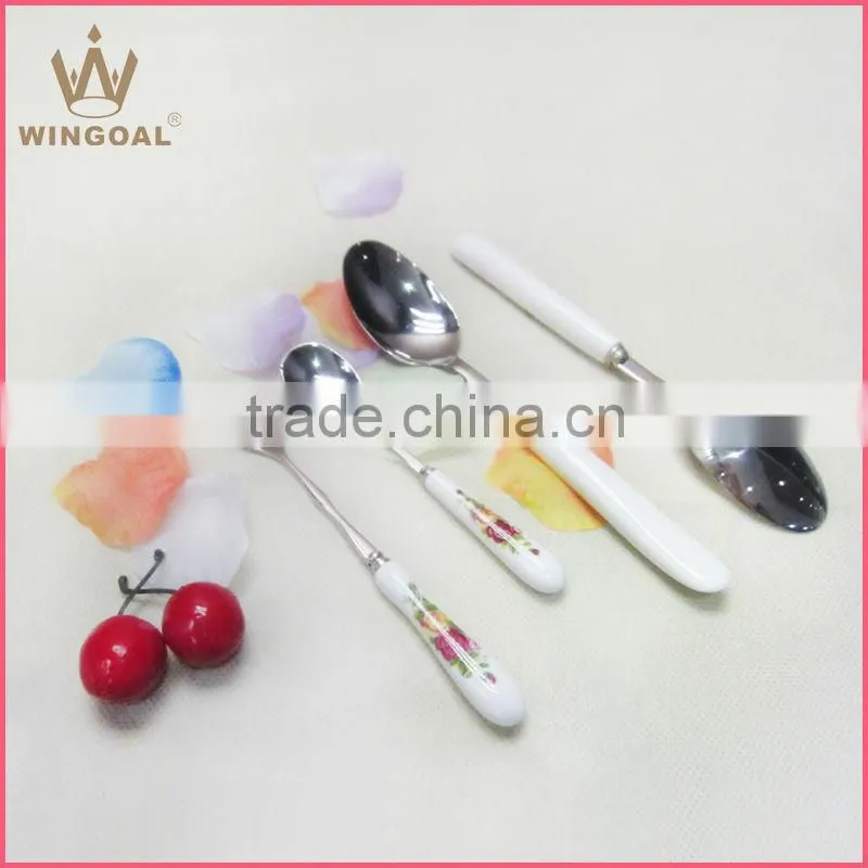 Stainless spoon with porcelain handle