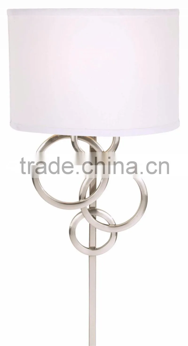 1017-1 sleek brushed steel finish raindrops falling on a calm body of water intertwining Circles Plug-In Wall Sconce