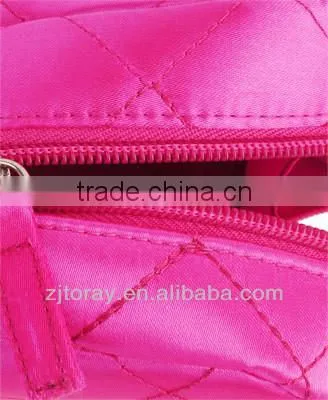 Lightweight quilted cosmetic bag featuring a zippered placket along the top and sides