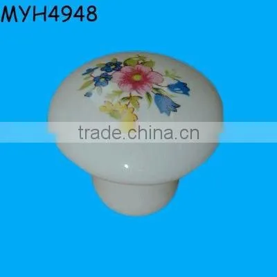 Plain white ceramic door knob with gold trim