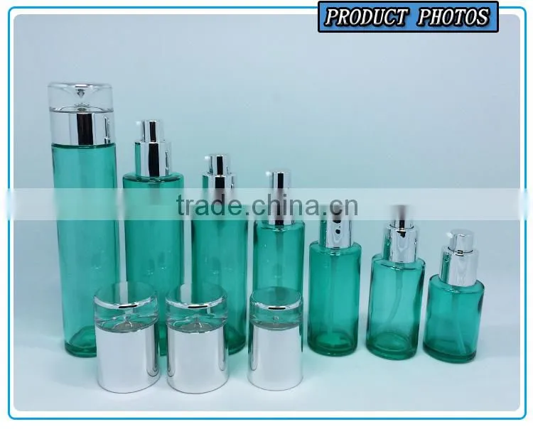 Empty green colored glass cosmetic bottle and cosmetic glass cream jar
