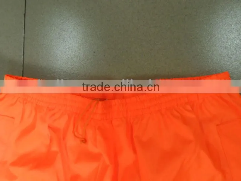 high visibility orange safety rainsuit with yellow plastic tapes