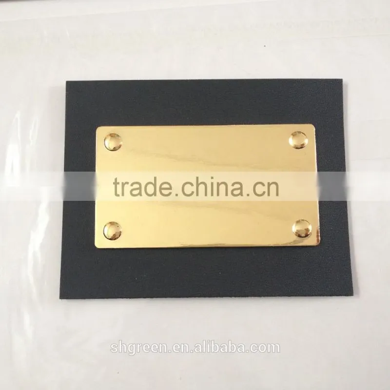 Shiny golden color metal badge on black leather