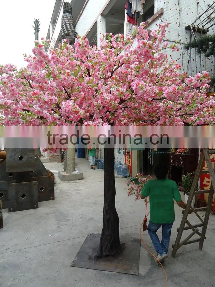Pink artificial cherry blossom trees with rotating base