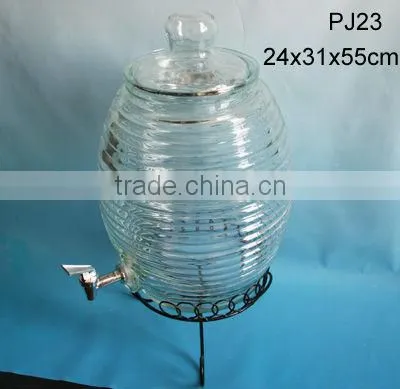 large clear drum shaped glass jar with glass lid and tap