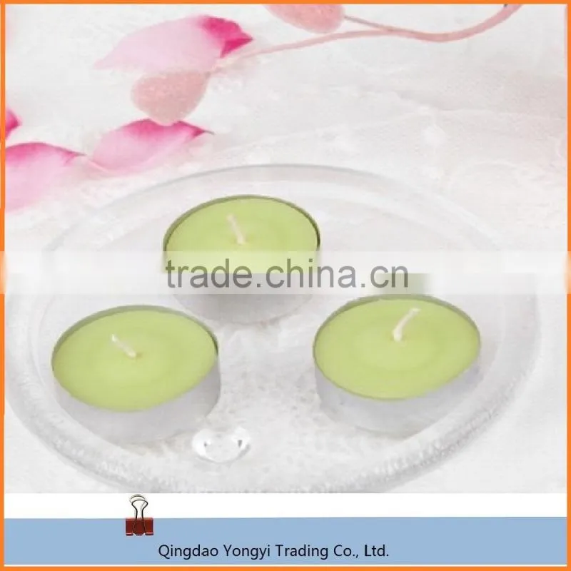 scented and colored tealight candle in plastic cup