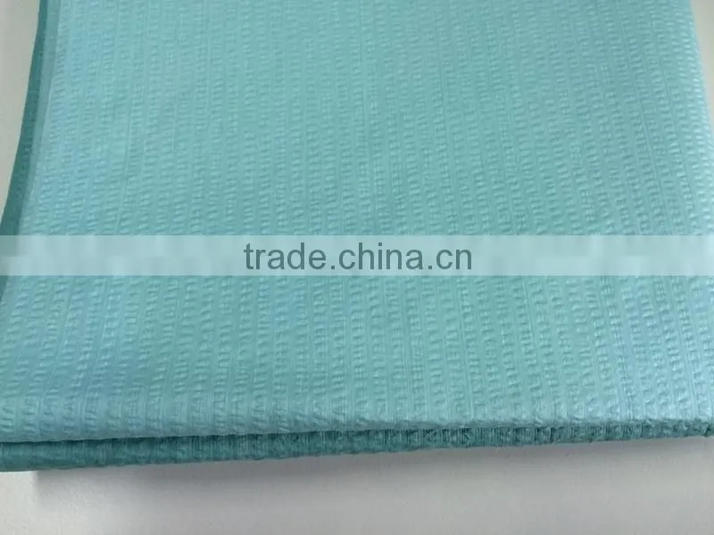 Creped nonwoven spunlace woodpulp polyester