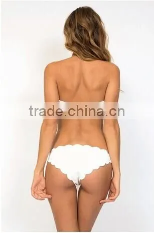 Strapless raw scallop bikini top has signature gold metal back hook closure.