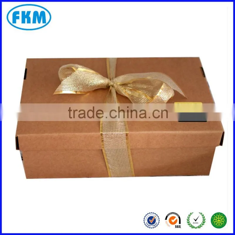 Ribboned brown card gift box packed with shredded paper