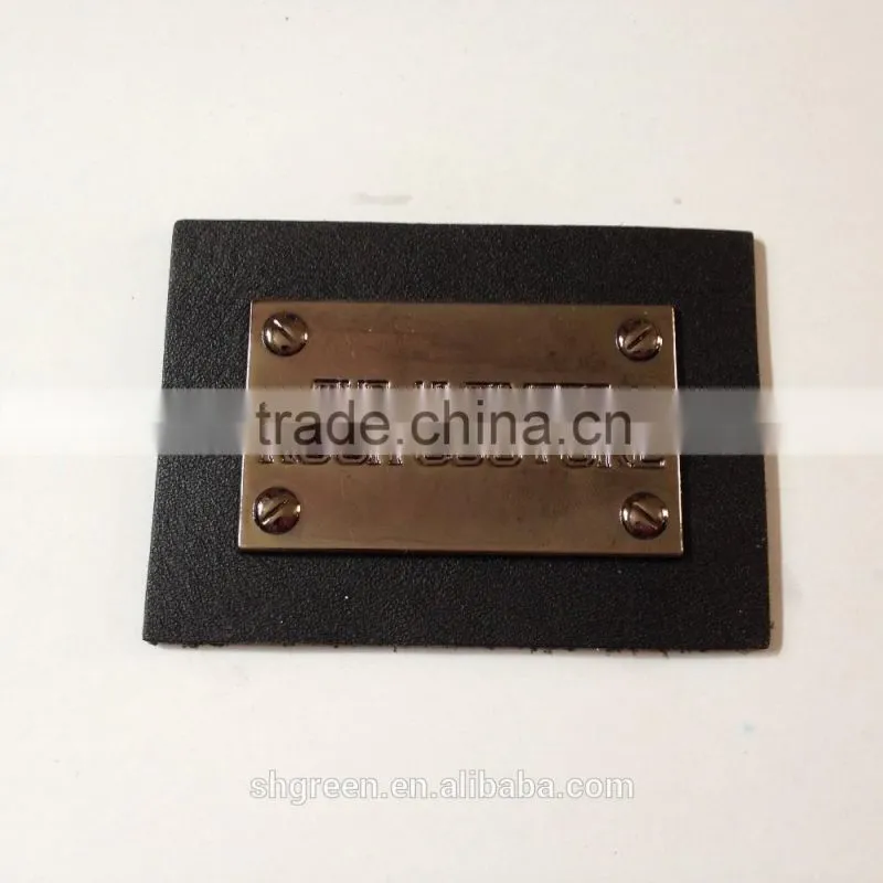 Shiny golden color metal badge on black leather