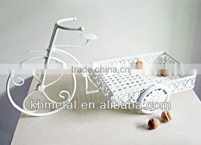 white three-wheel cart fruit plates
